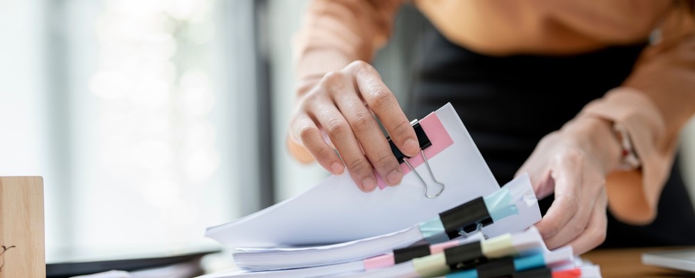 Person looking through multiple documents