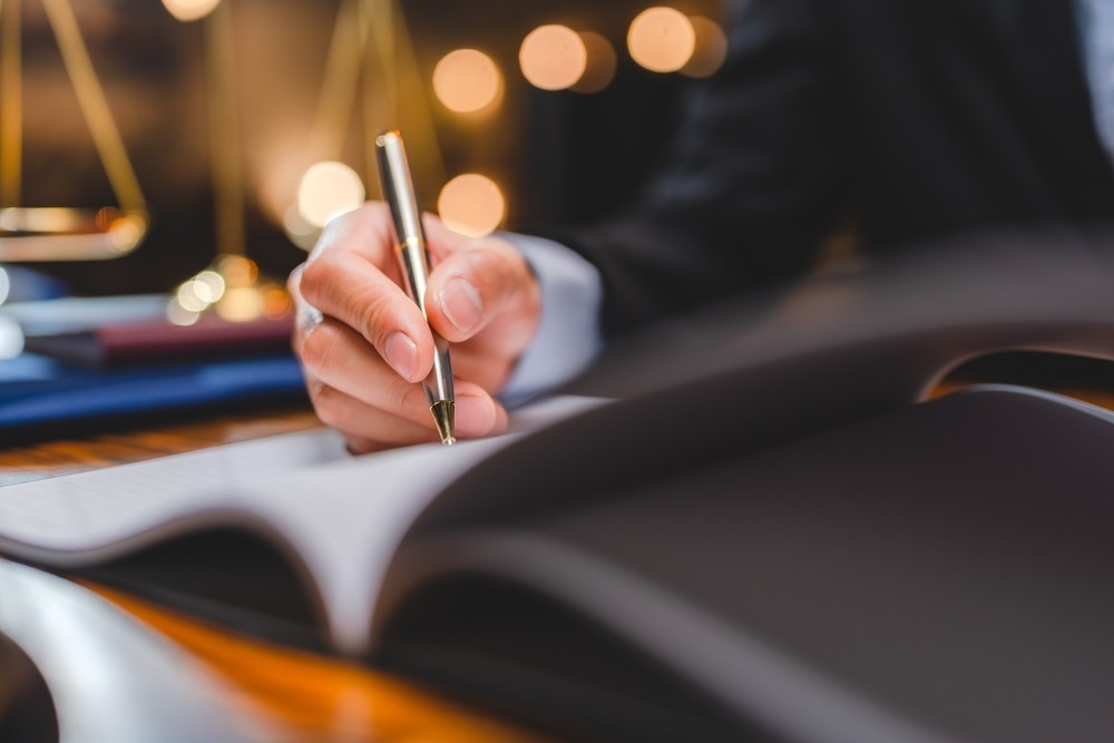 A business person signing a document
