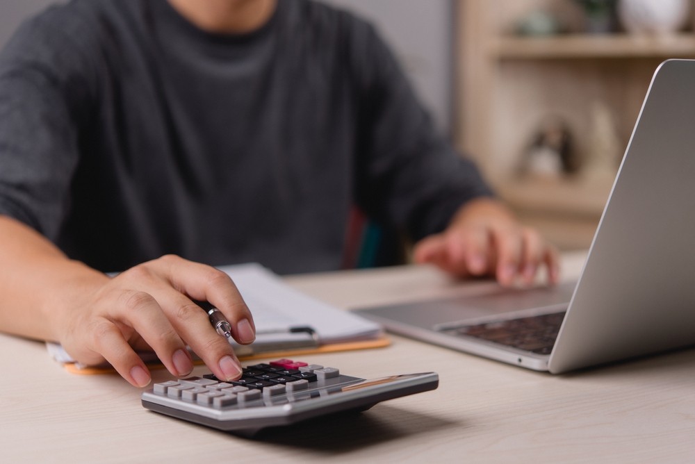 Person using a calculator at a desk