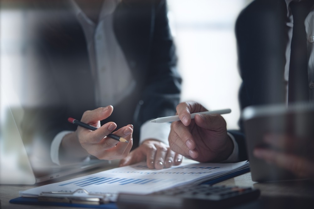 Two people looking over a business document