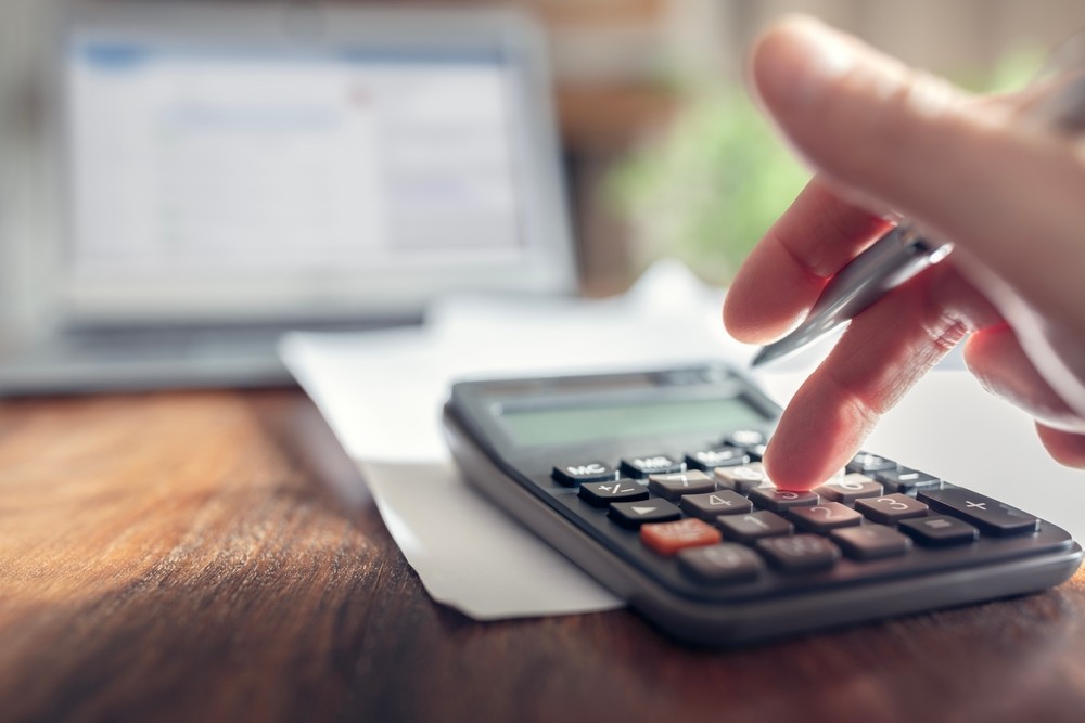 Someone using a calculator on a desk