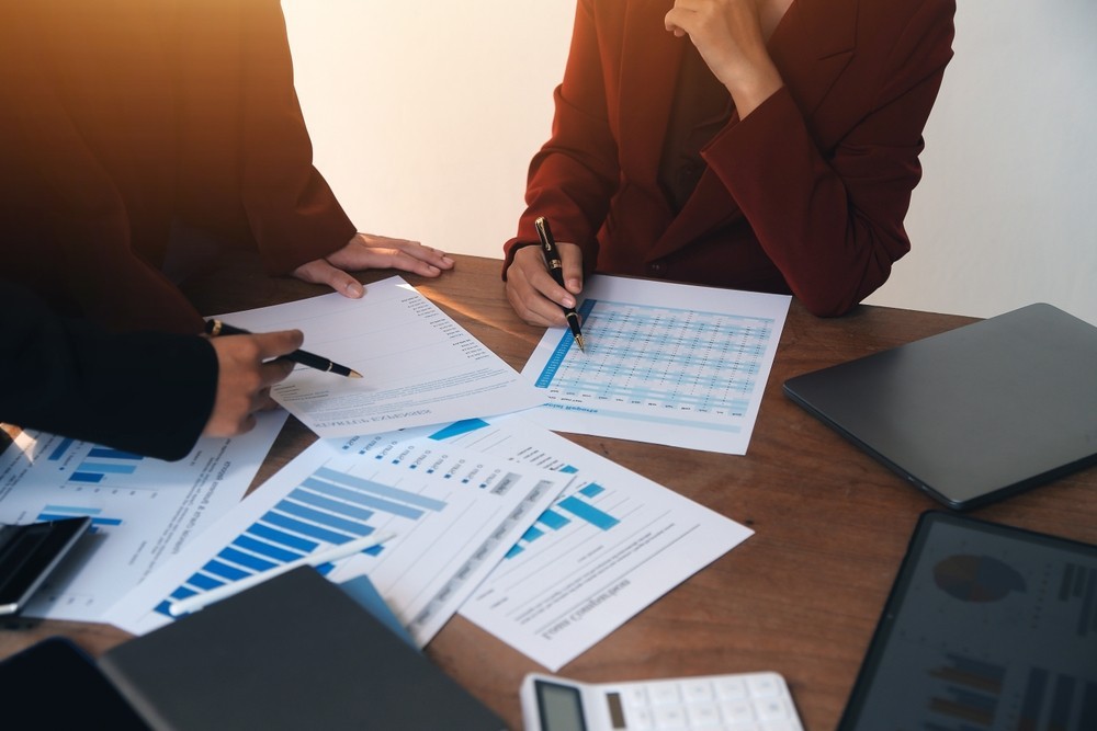 Group of business people looking at a series of documents
