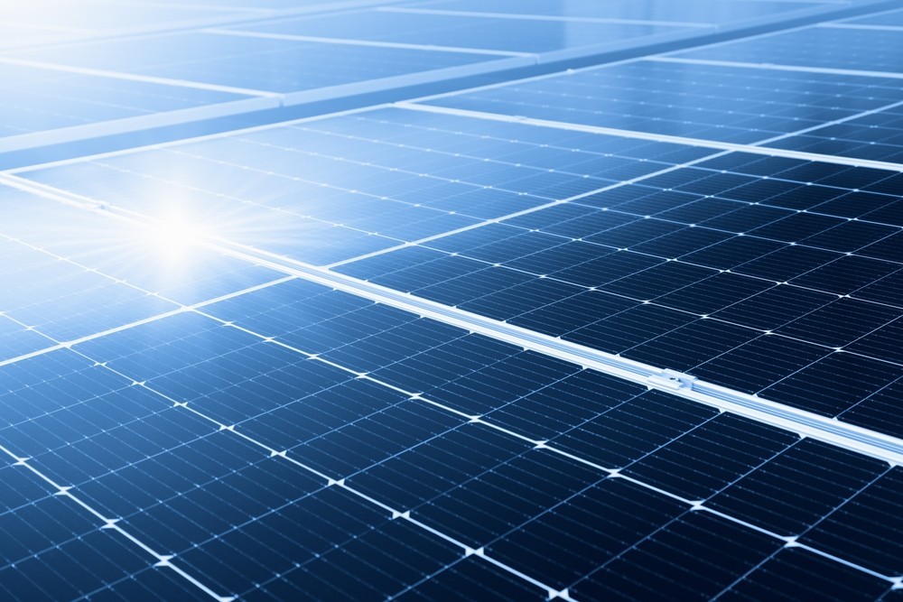 Solar panels with the sun shining on them