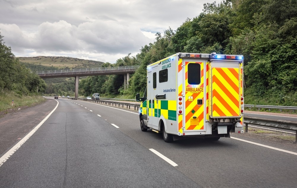 An ambulance driving down the road