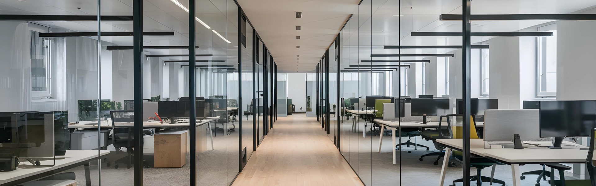 Modern office interior showing desks, monitors, and chairs