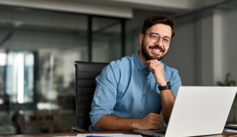 People looking at the camera in business clothing with a laptop