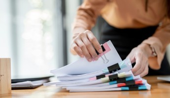 Person looking through multiple documents