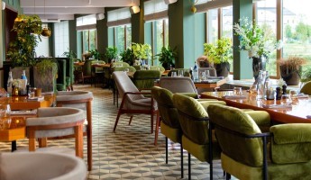 The interior of a restaurant with tables and chairs
