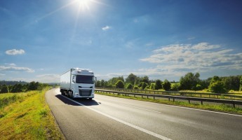 A HGV driving down a road in nice weather
