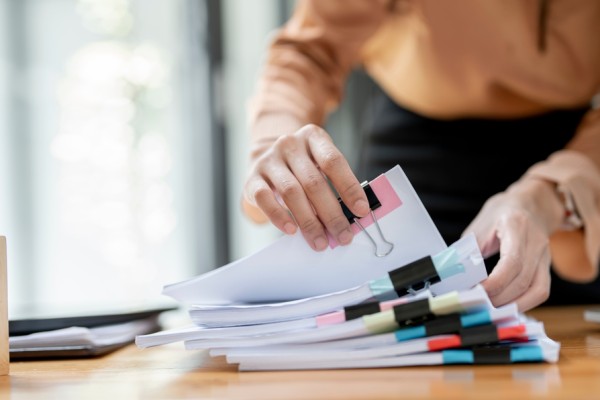 Person looking through multiple documents