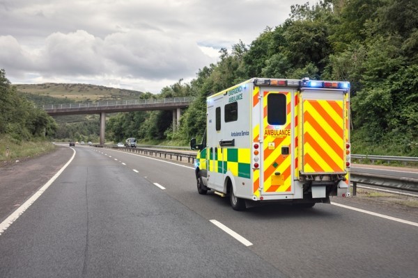 An ambulance driving down the road
