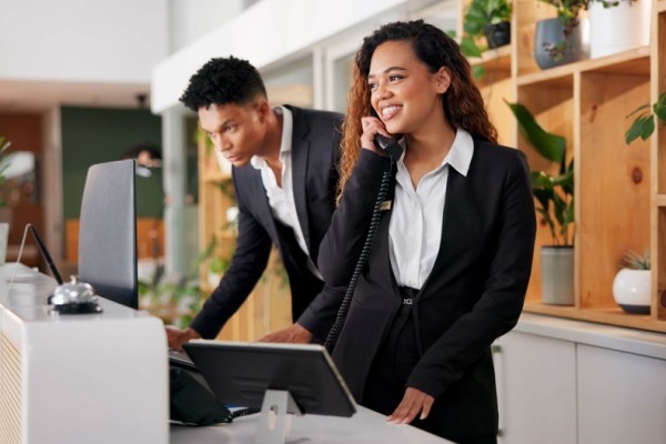 Two people stood at reception of a venue