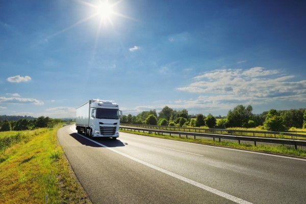 A HGV driving down a road in nice weather