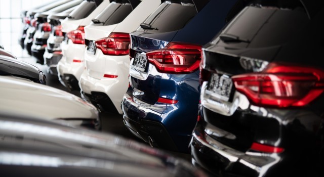 Boot of multiple cars parked in a dealership