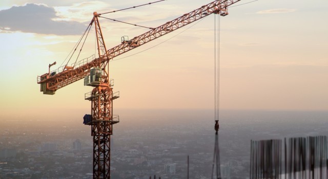 A crane working on a skyscraper building