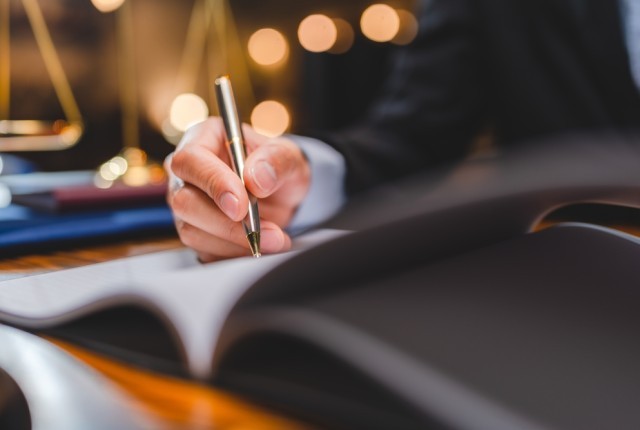 A business person signing a document