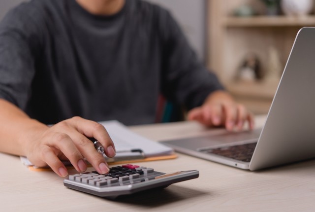 Person using a calculator at a desk