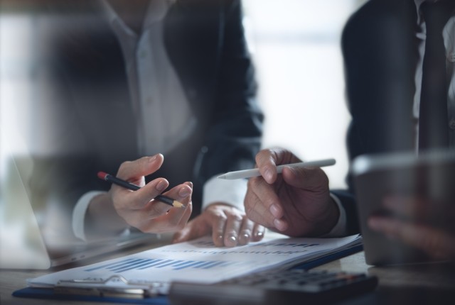 Two people looking over a business document