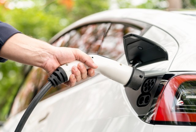 Photo of an electric car charging. 