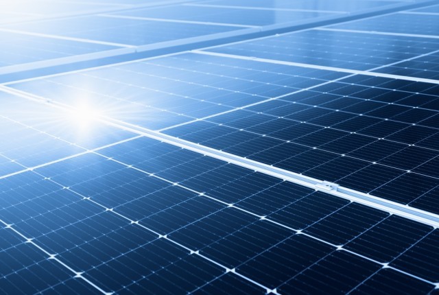 Solar panels with the sun shining on them
